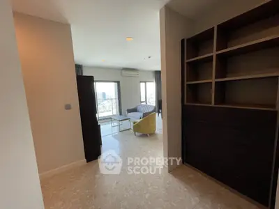 Spacious living room with modern furniture and city view, perfect for urban living.