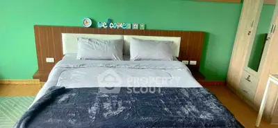 Cozy bedroom with modern decor and green accent wall