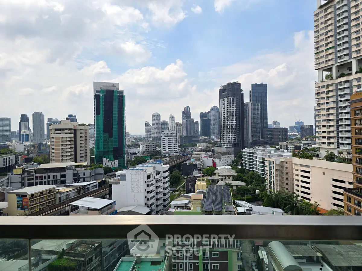 Stunning cityscape view from a high-rise balcony showcasing urban skyline and modern architecture.