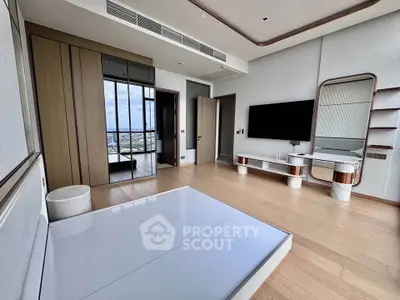 Spacious modern bedroom with sleek design and large windows offering city views.
