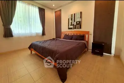 Spacious bedroom with elegant decor and natural light