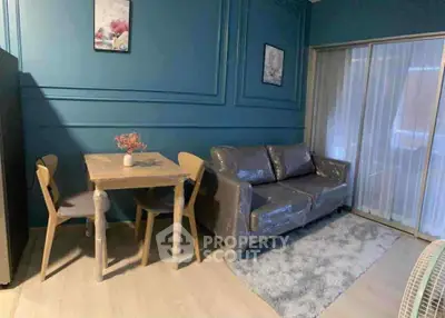 Cozy living room with modern decor and compact dining area