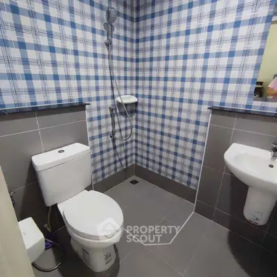Modern bathroom with plaid tile design and sleek fixtures