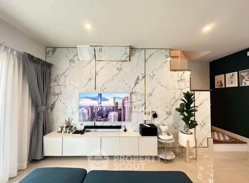 Modern living room with marble accent wall and sleek entertainment center