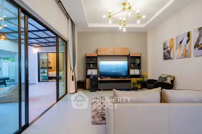 Modern living room with stylish decor and open layout leading to a spacious balcony.