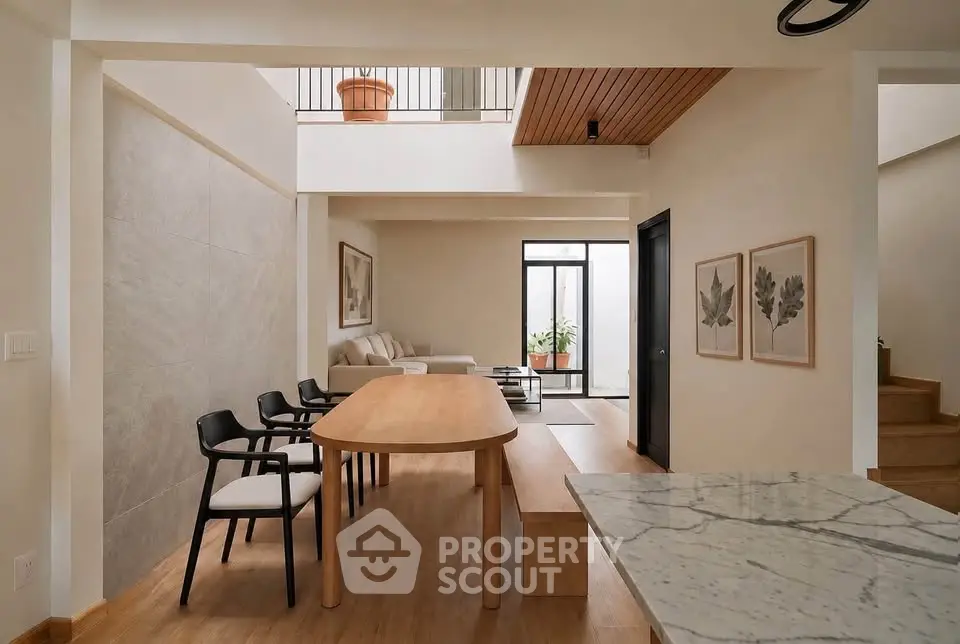 Modern open-plan living and dining area with stylish decor and natural light.