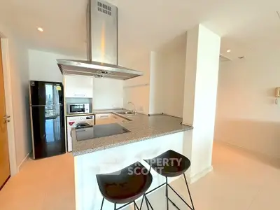 Modern kitchen with sleek appliances and breakfast bar in a bright apartment