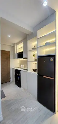 Modern kitchen with sleek appliances and open shelving in a compact layout.