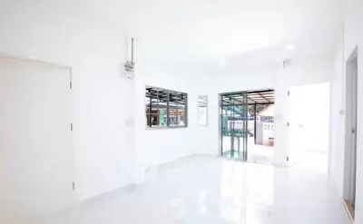Bright and airy living room with large windows and white walls, perfect for modern living.