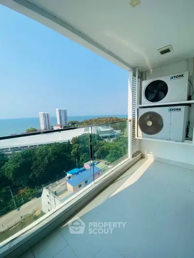 Stunning balcony view with ocean and cityscape, perfect for relaxation and enjoying the scenery.