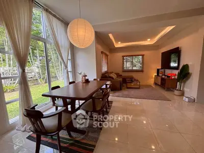 Spacious living room with elegant dining area and garden view.