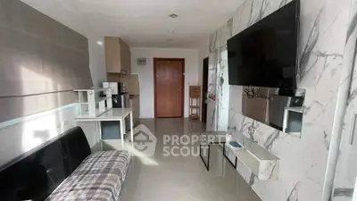 Modern living room with marble accents and wall-mounted TV in stylish apartment.