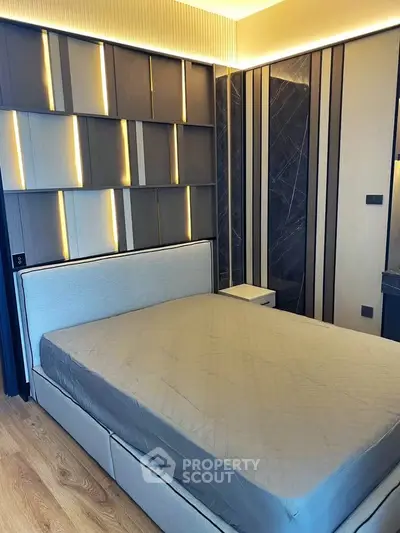 Luxurious modern bedroom with stylish wall paneling and elegant lighting