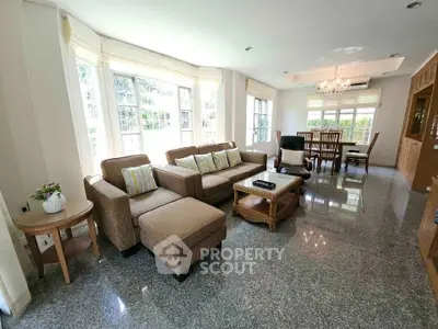 Spacious living room with elegant furniture and large windows offering natural light