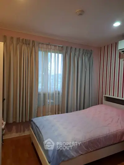 Cozy bedroom with soft lighting and elegant curtains, perfect for relaxation.