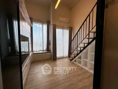 Spacious modern living room with loft and large windows offering stunning views.