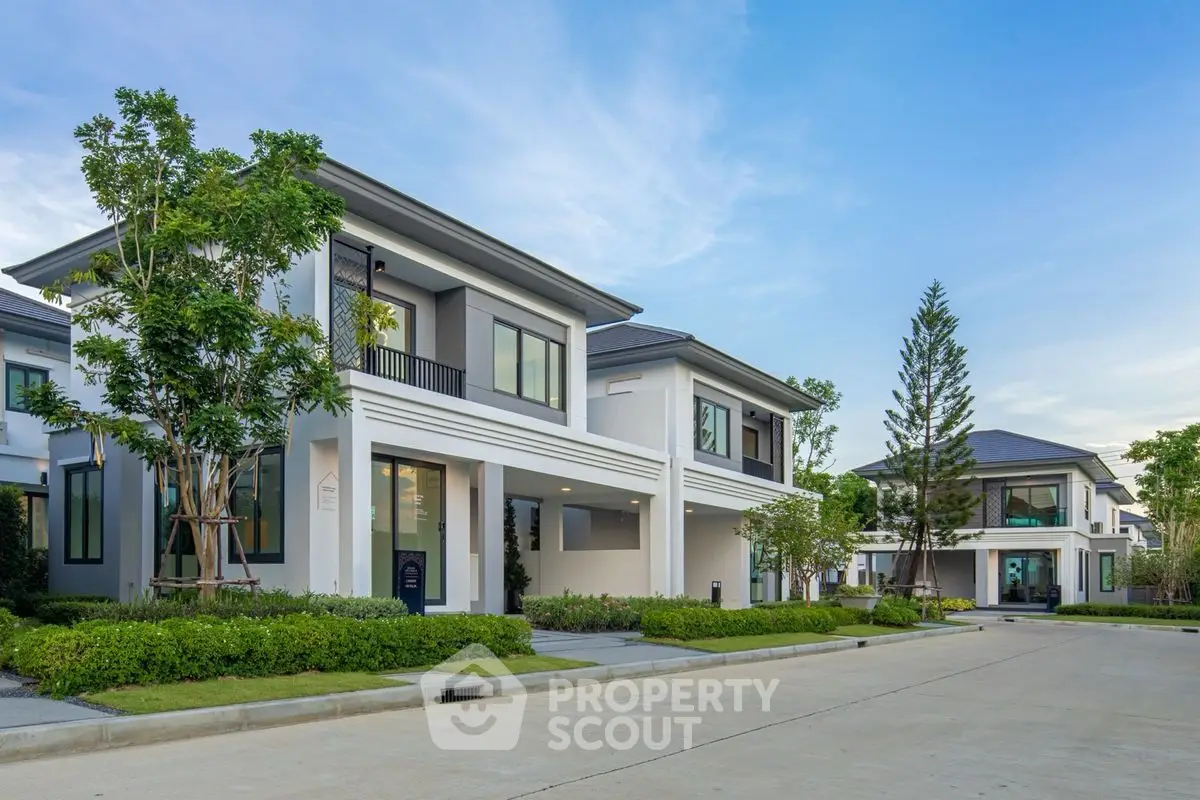 Modern two-story house with lush landscaping and spacious driveway