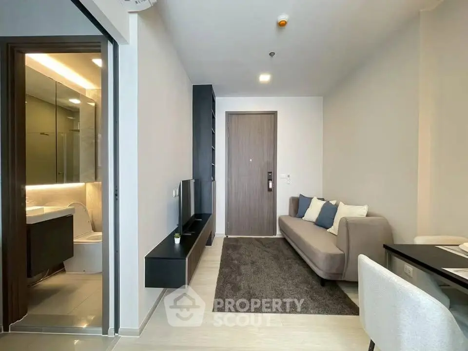 Modern living room with sleek design and cozy seating in a contemporary apartment.