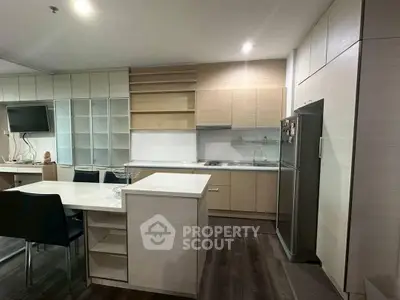 Modern kitchen with sleek cabinetry and integrated appliances in a stylish apartment.