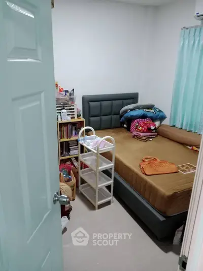 Cozy bedroom with modern bed and organized storage, perfect for comfortable living.