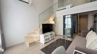 Modern duplex living room with stylish staircase and cozy seating area