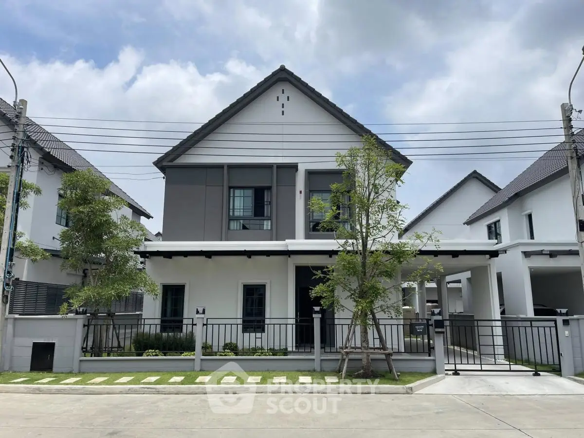 Modern two-story house with sleek design and landscaped front yard