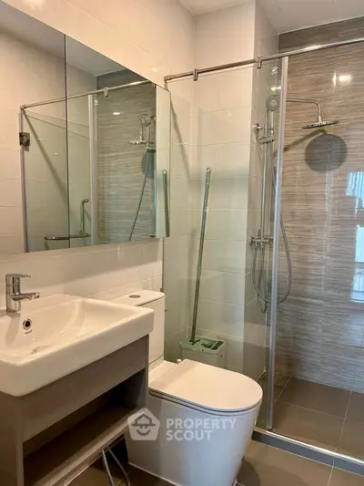 Modern bathroom with glass shower and sleek fixtures