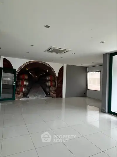 Spacious modern interior with unique wall art and glossy tiled flooring