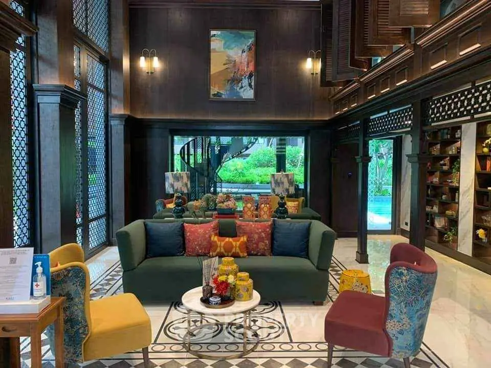 Luxurious living room with high ceilings, elegant decor, and garden view, perfect for sophisticated gatherings.