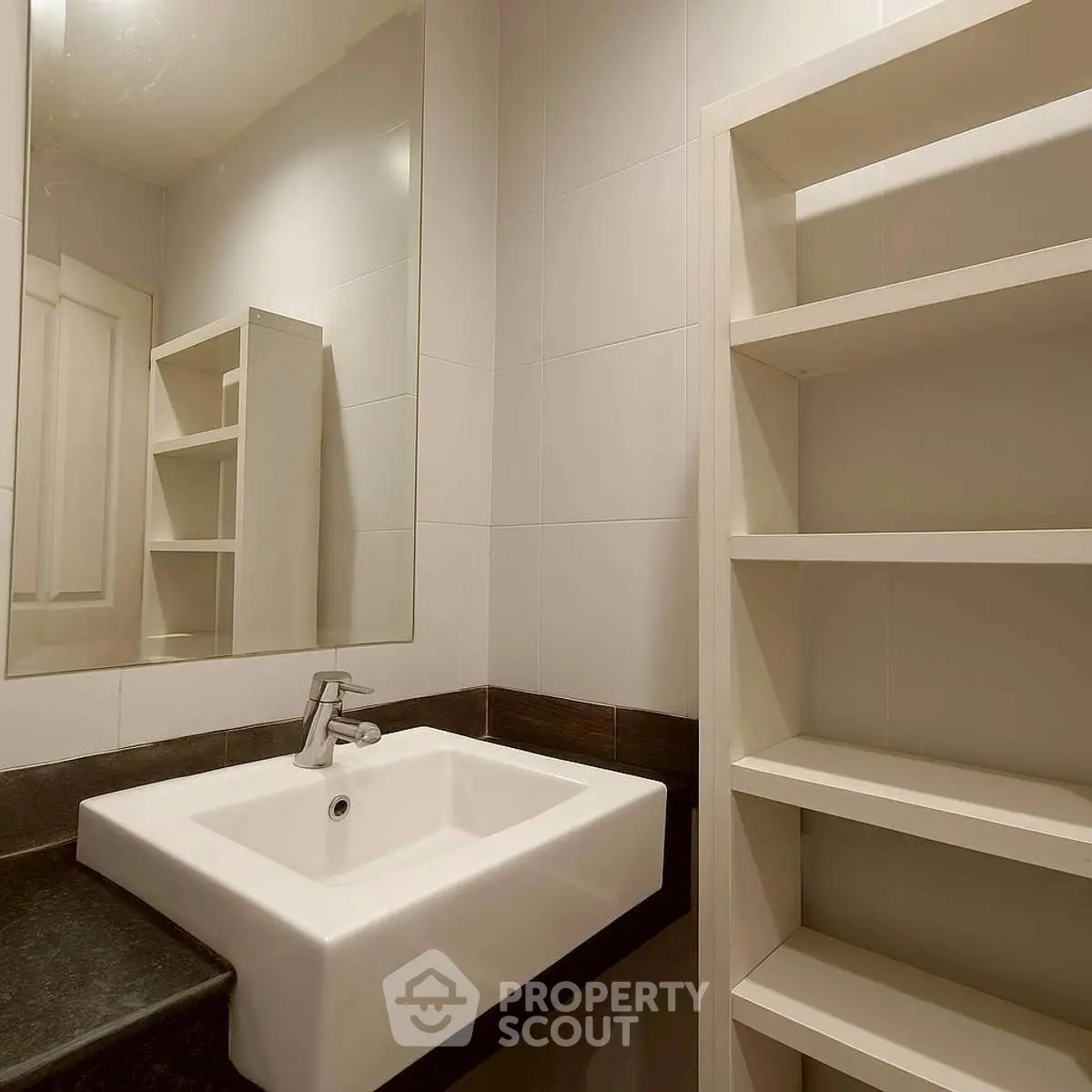 Modern bathroom with sleek sink and open shelving