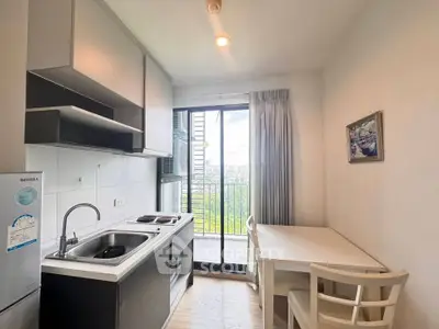 Modern kitchen with balcony view, sleek design, and natural light