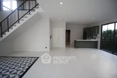 Spacious modern living room with open kitchen and stylish staircase