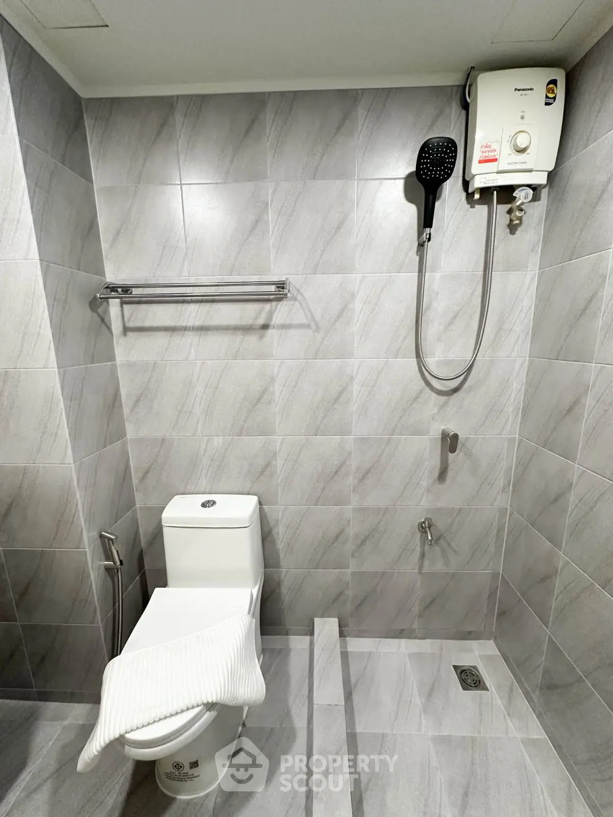 Modern bathroom with sleek gray tiles and efficient water heater
