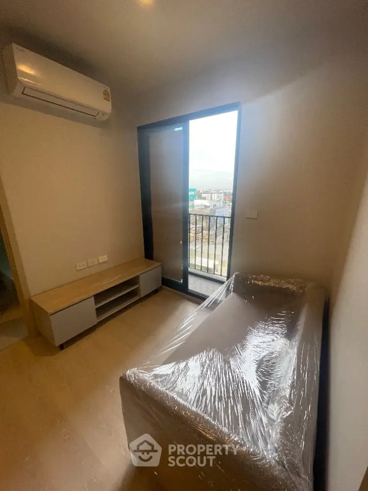 Cozy bedroom with balcony access in modern apartment