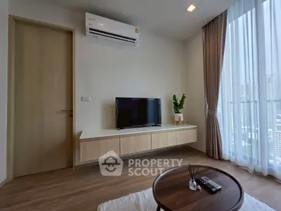Modern living room with air conditioning and city view, featuring sleek furniture and natural light.