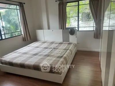 Spacious bedroom with large windows and modern decor