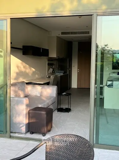 Modern apartment with open layout, featuring cozy living area and sleek kitchen design.