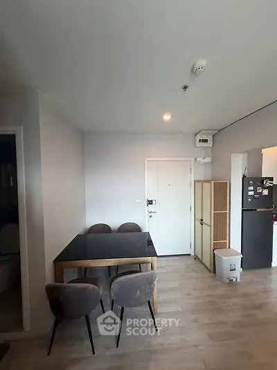 Modern dining area with sleek table and chairs in a stylish apartment interior.