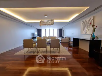 Spacious modern living room with elegant lighting and hardwood floors
