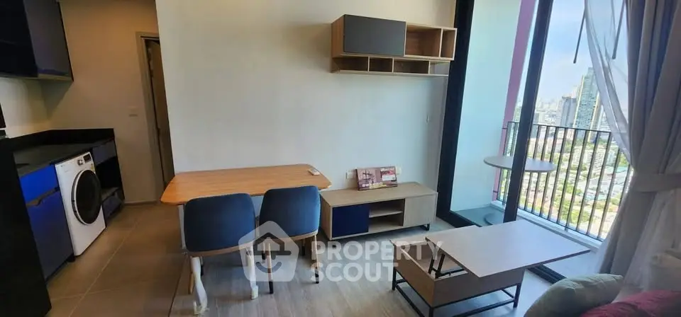 Modern living room with balcony view and stylish furniture in urban apartment.