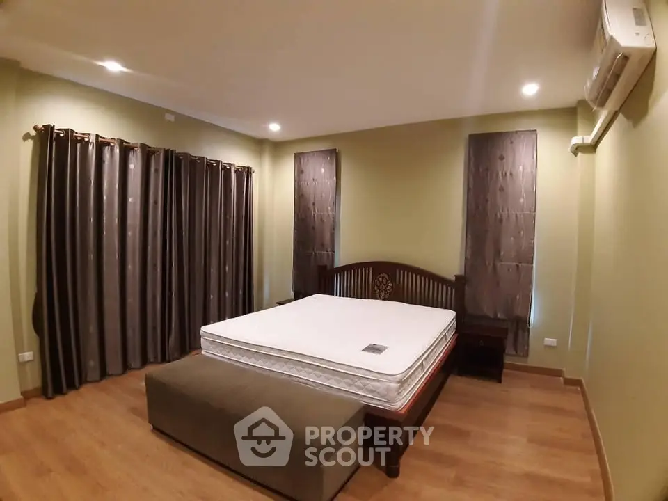 Spacious bedroom with elegant wooden bed and cozy lighting