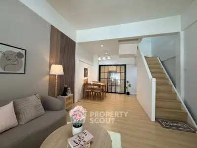 Spacious modern living room with stylish decor and wooden staircase