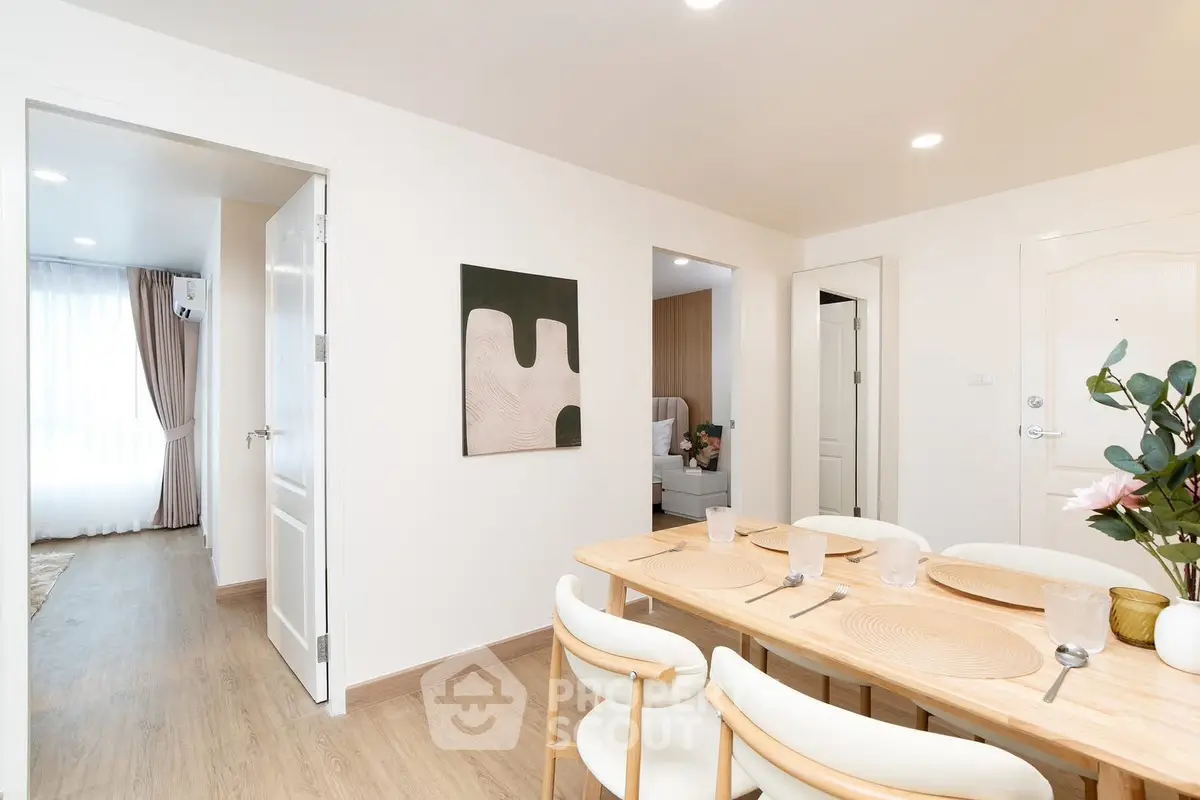 Modern dining area with elegant table setting and bright natural light