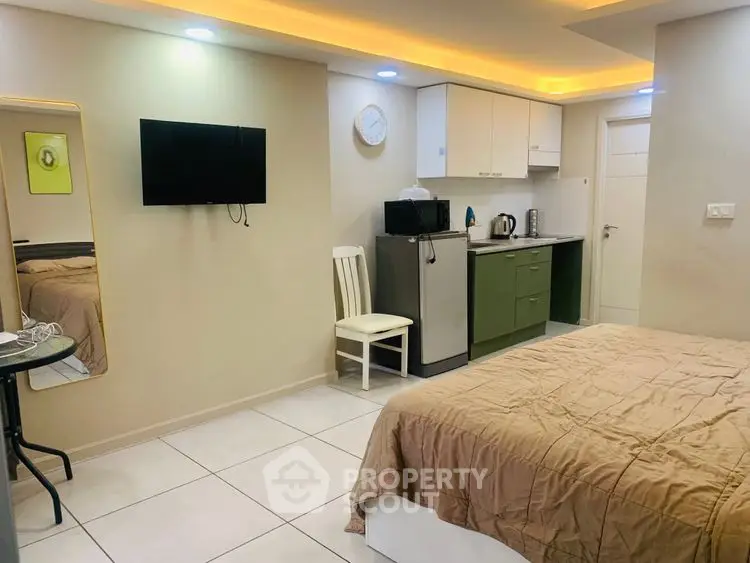 Cozy studio apartment with modern kitchenette and stylish lighting