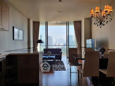 Luxurious living room with stunning city view, elegant chandelier, and modern furnishings in high-rise apartment.