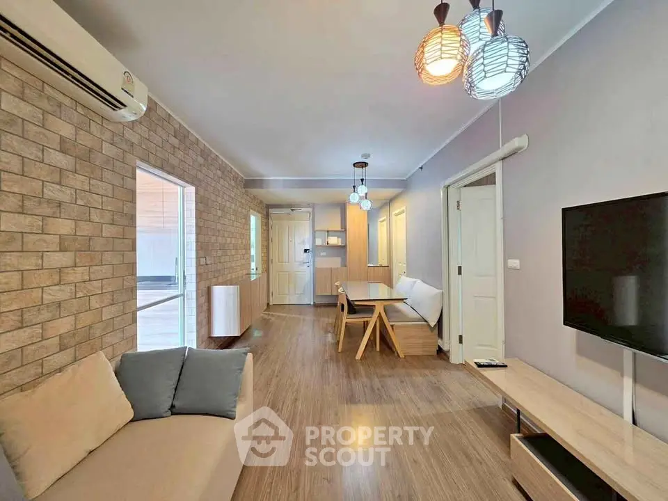 Modern living room with stylish lighting and cozy seating area in a contemporary apartment.
