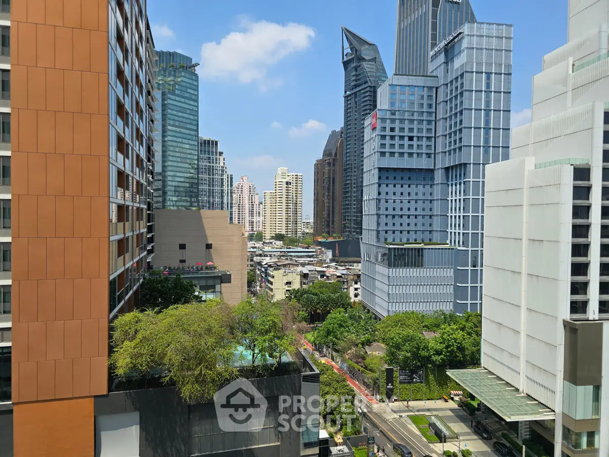 Stunning cityscape view from a high-rise building showcasing modern architecture and lush greenery.