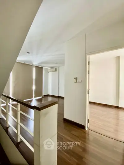 Spacious modern interior with wooden flooring and natural light