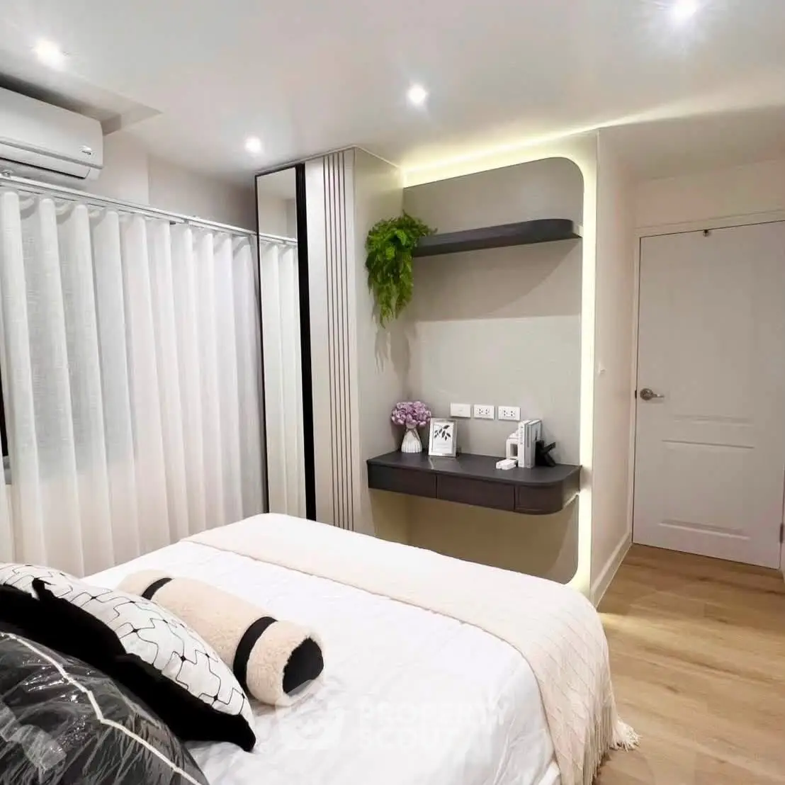 Modern bedroom with stylish decor, featuring a cozy bed, sleek shelves, and ambient lighting.