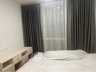 Cozy bedroom with elegant curtains and soft bedding